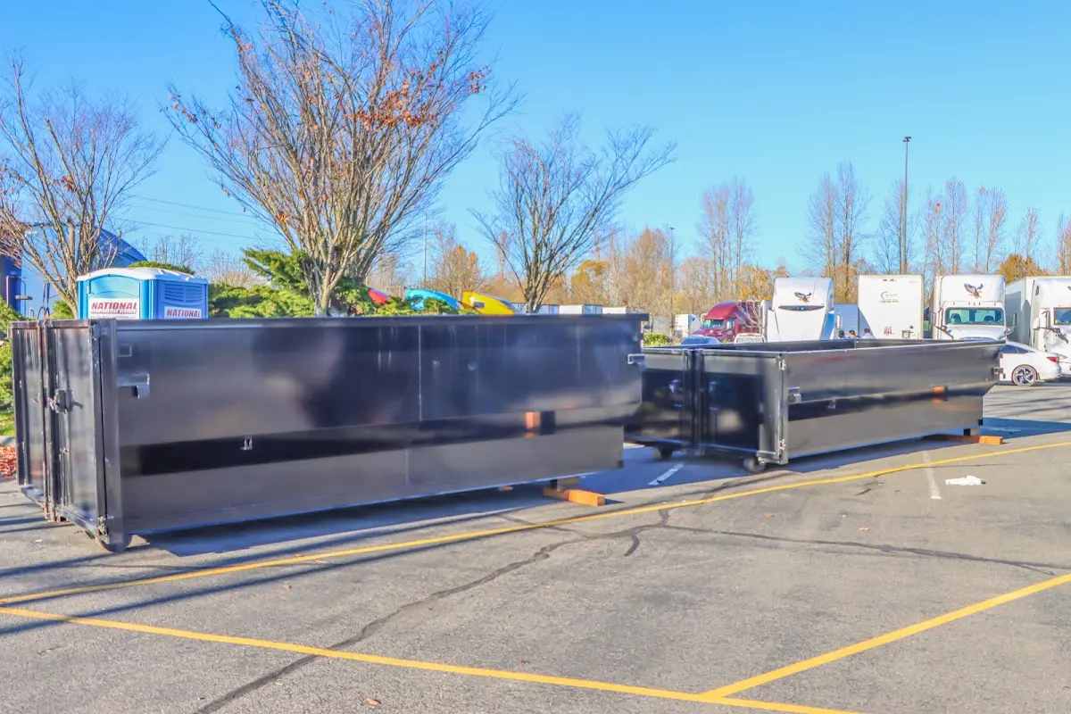 Professional dumpster rental service with roll-off container on residential driveway in Dumas